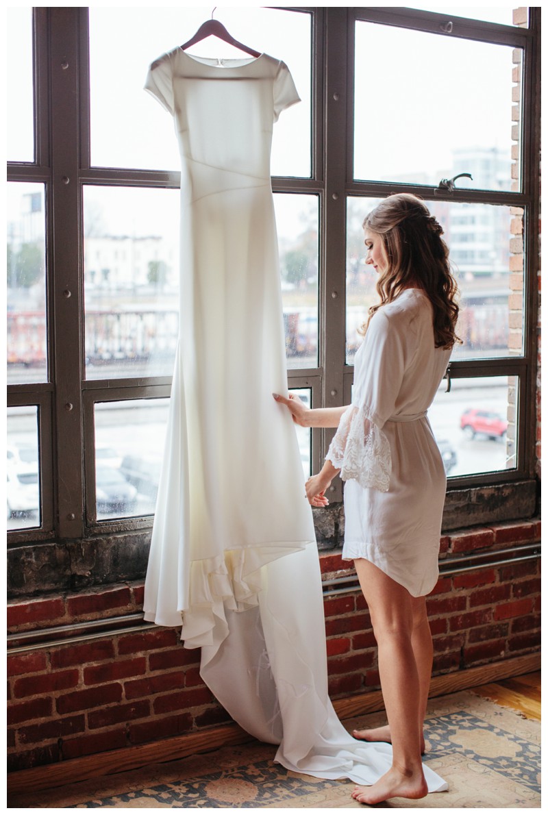 Bride gazing at details of wedding dress at The Standard Downtown Knoxville 