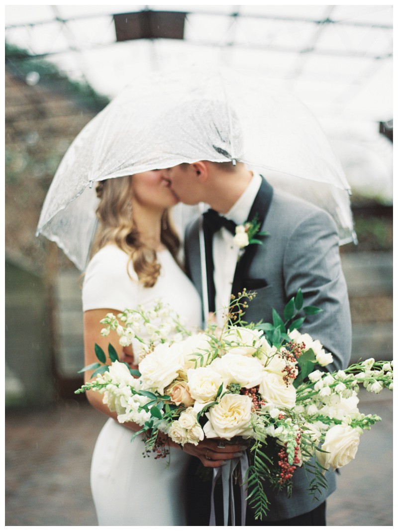 bride and groom kiss in rain at the standard knoxville, tn