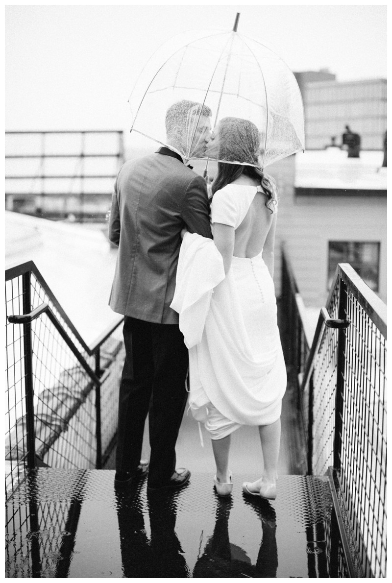 bride and groom kiss in rain at the standard knoxville, tn