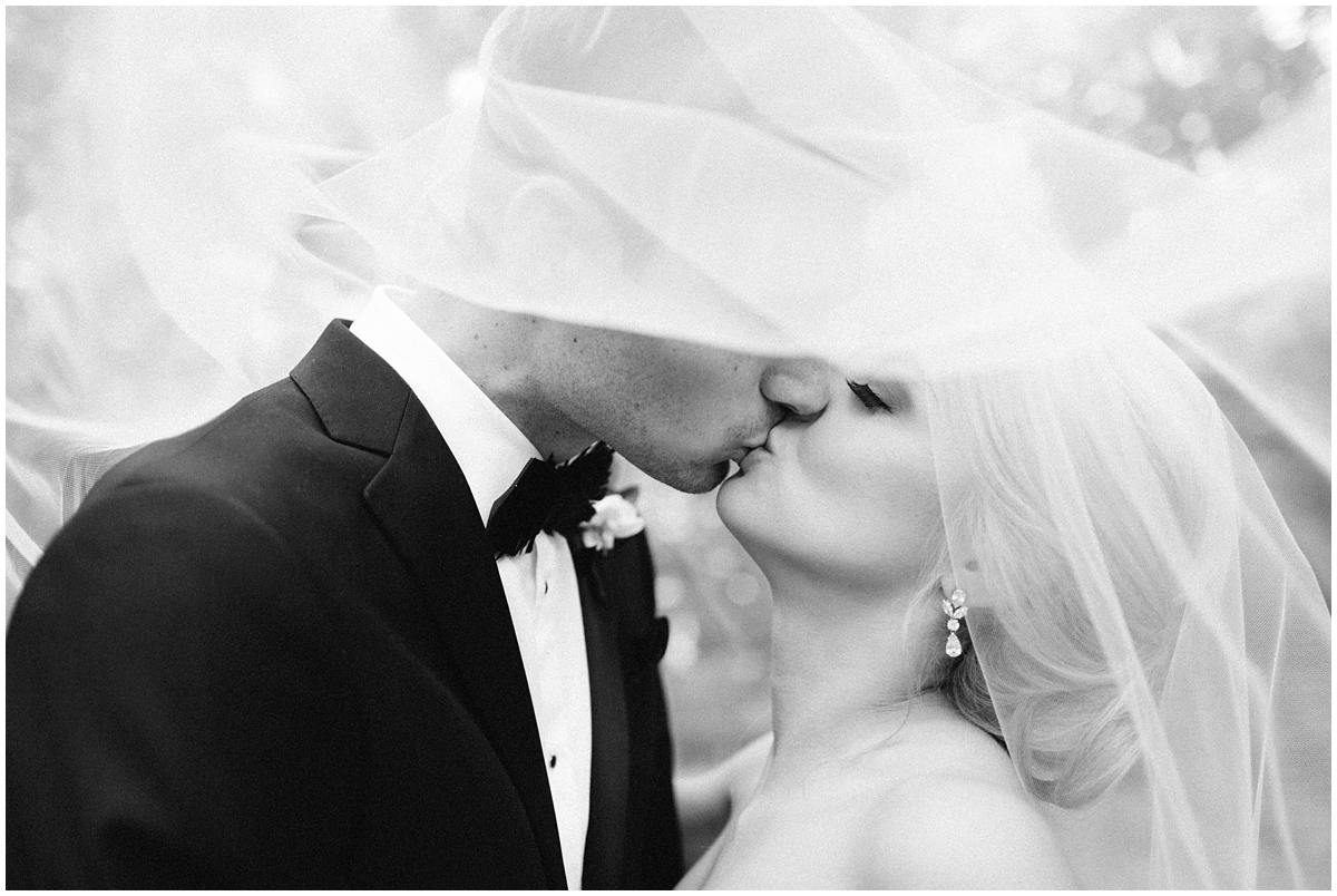 black and white photography bride and groom portraits kissing veil Charlotte nc wedding