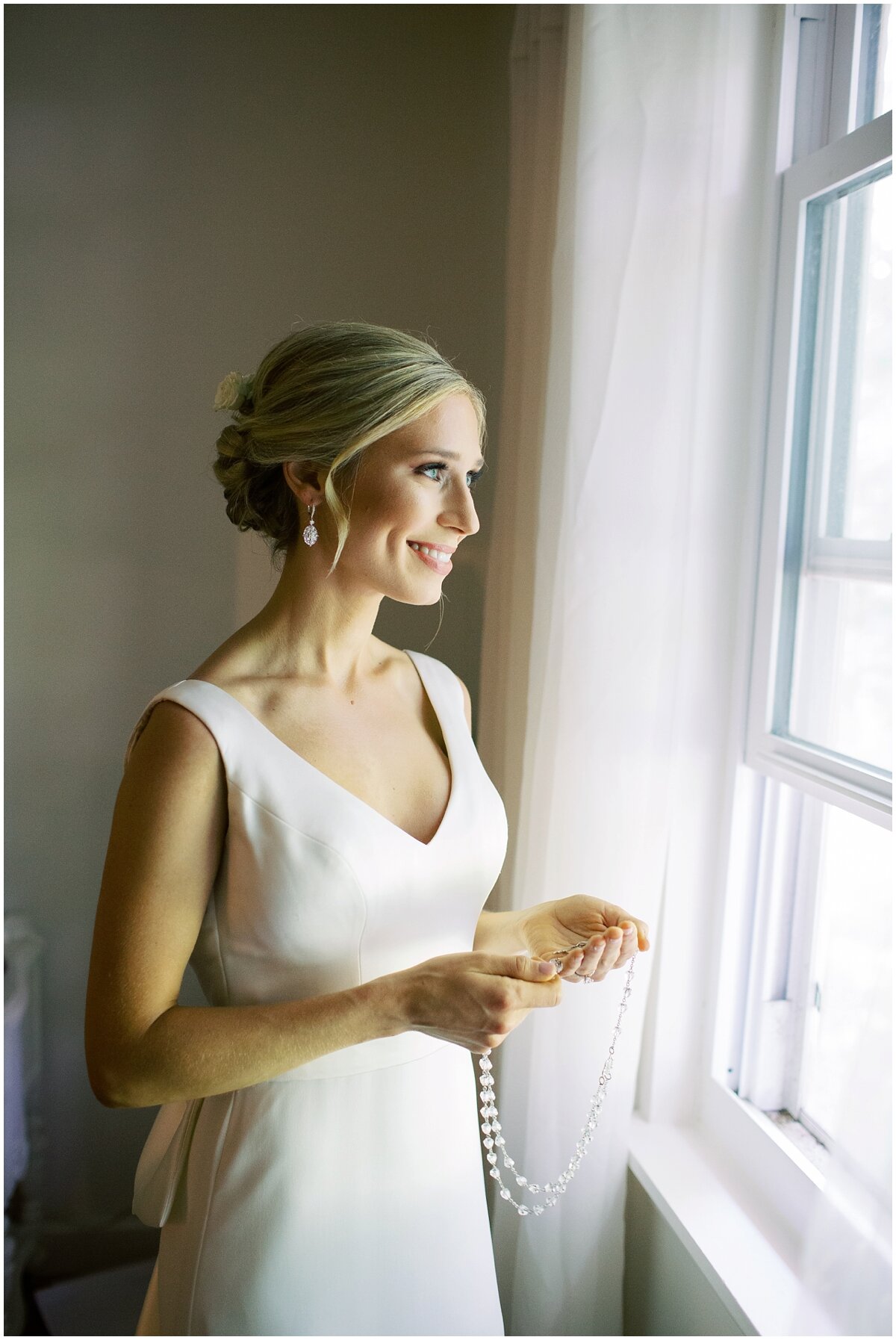 bride getting ready looking out window