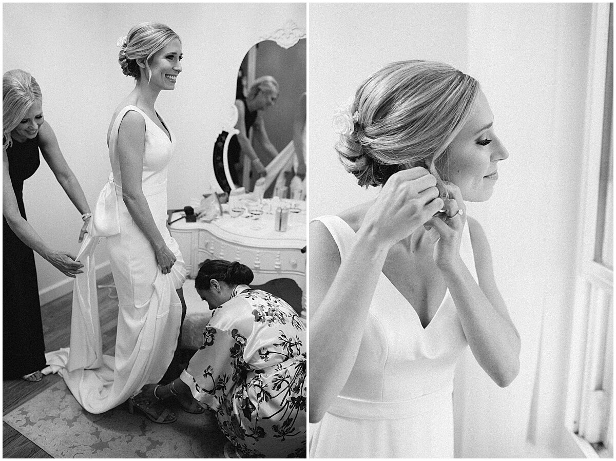 bride putting on dress and earrings 