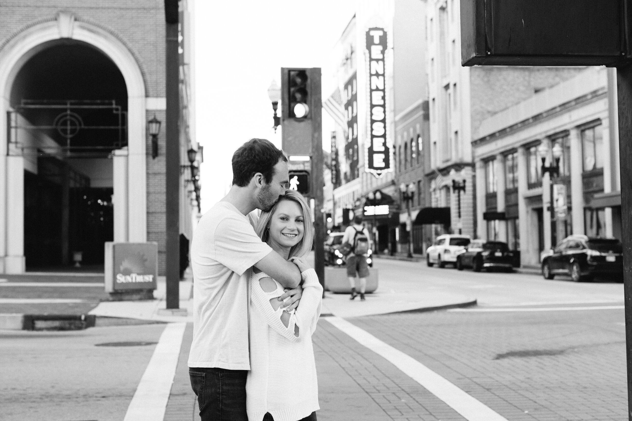 Couple taking Engagement Photos with Tennessee Theatre sign on Gay Street in Knoxville