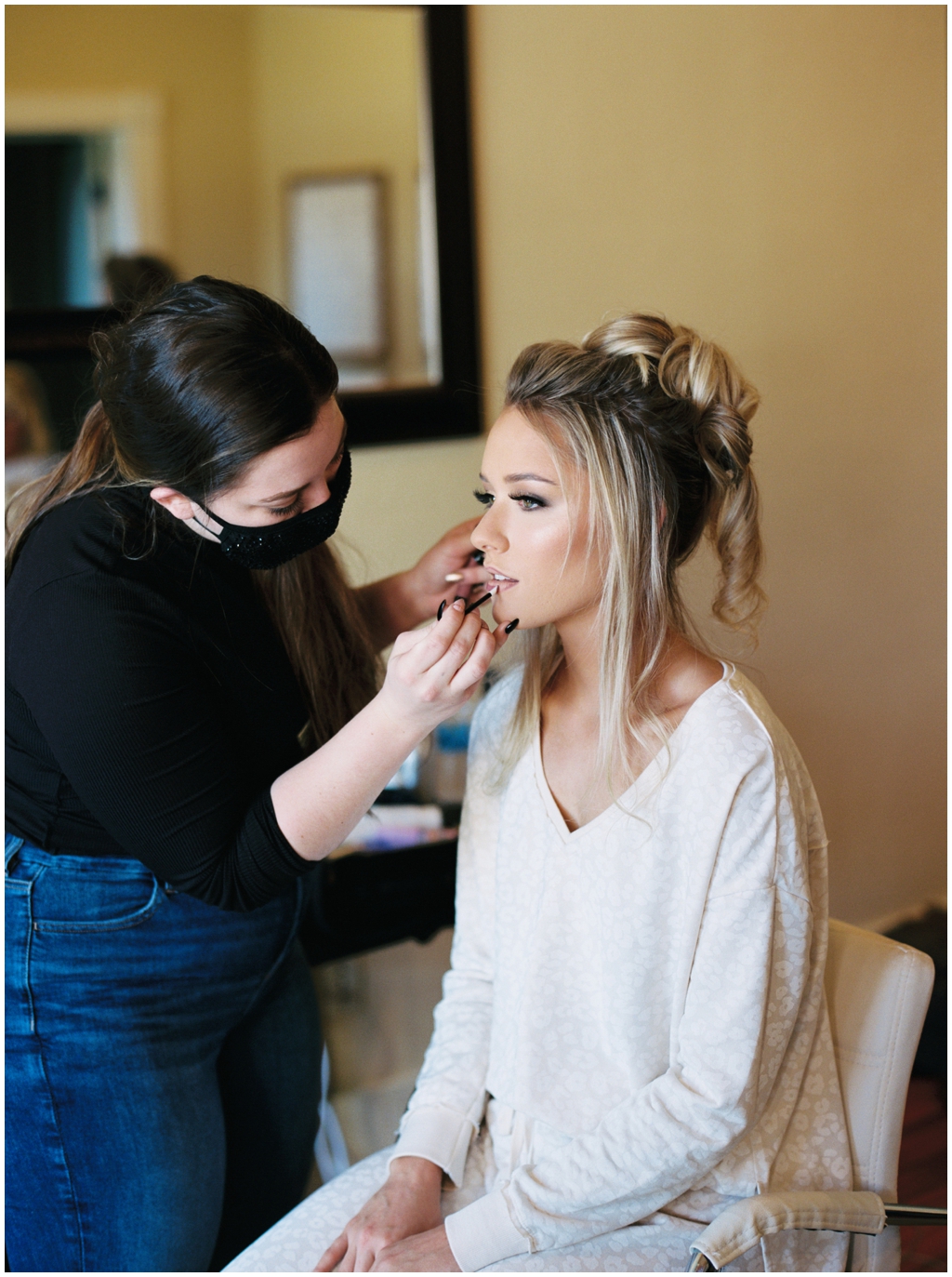 Emily Ann Roberts getting makeup applied on her wedding day