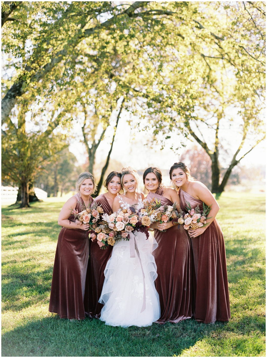 Deep burgundy velvet bridesmaids dresses and beautiful fall muted rose colored bouquets