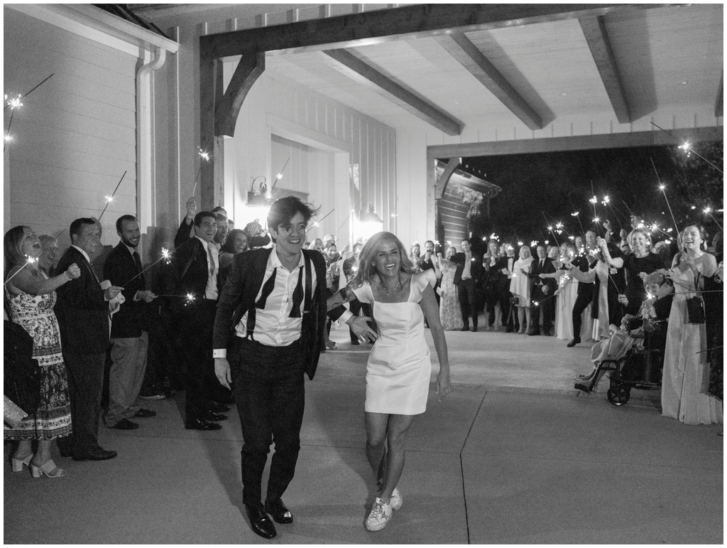 Bride and groom dashing through their sparkler exit