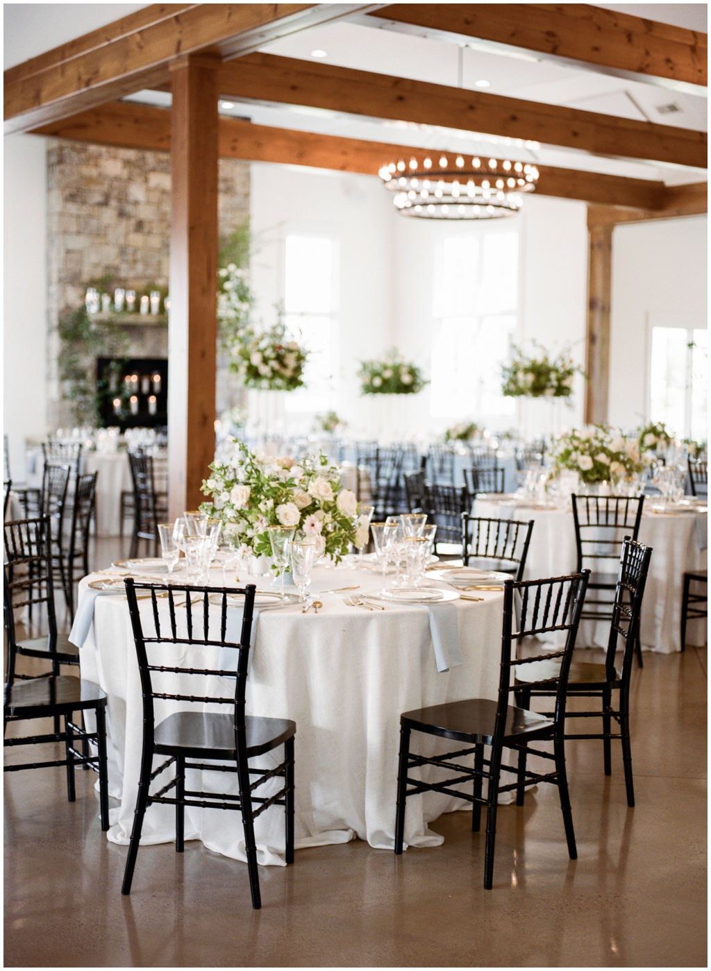 Timeless, simple indoor wedding reception decorated with lots of fresh greenery and roses at Marblegate Farm. 