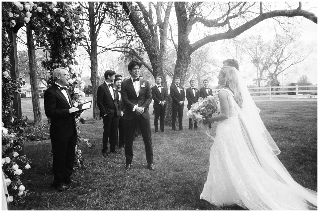 Film image of groom seeing his bride come down the aisle