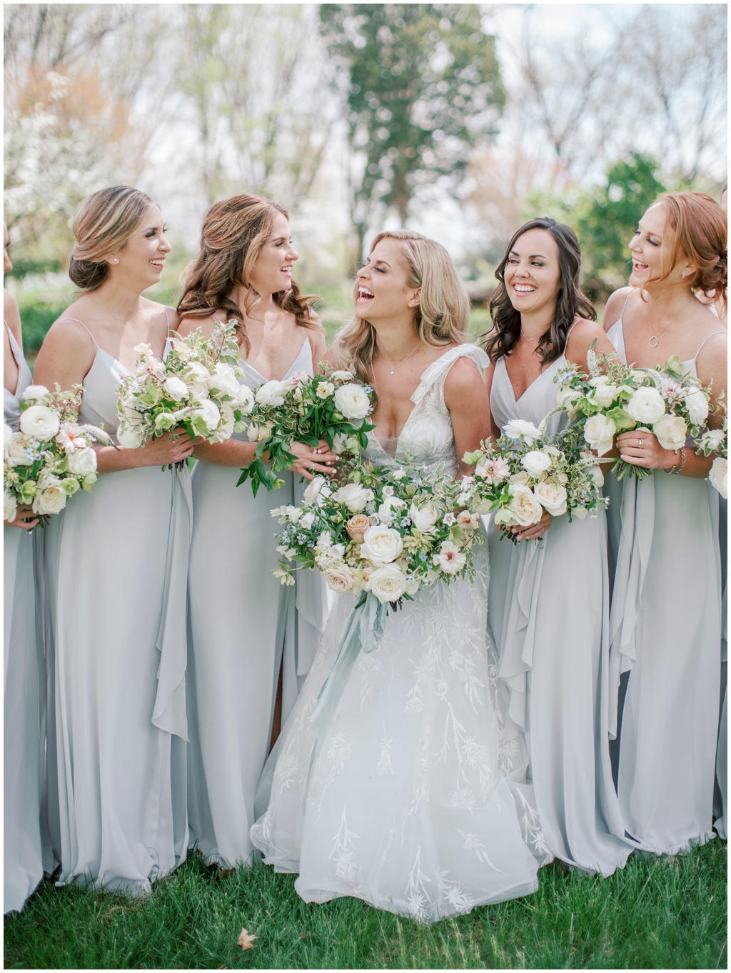 Soft gray blue bridesmaid dresses with full neutral charming rose bouquets