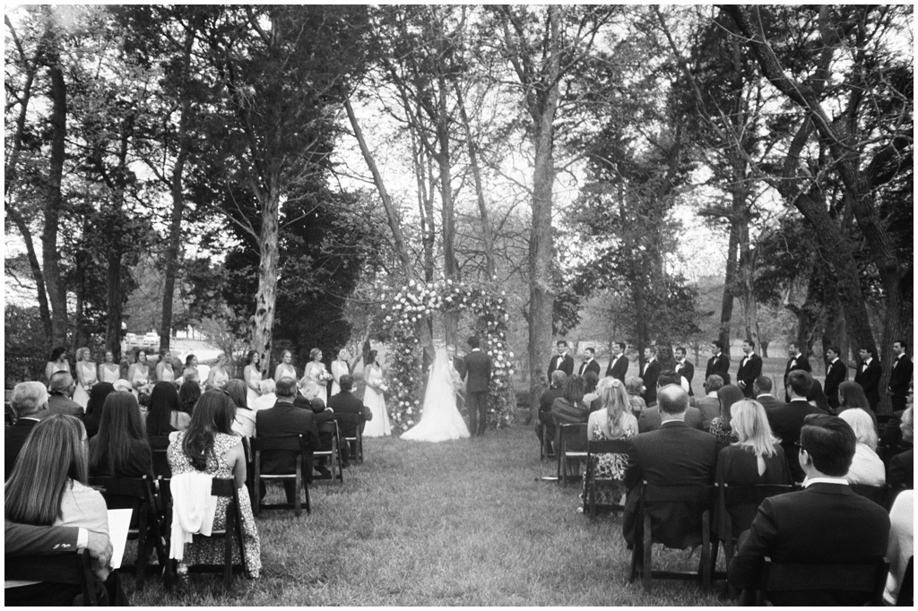 Black and white film image during the outdoor spring wedding ceremony at Marblegate Farm