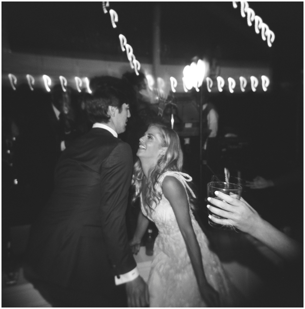 Black and white film image of bride and groom dancing at Marblegate Farm wedding