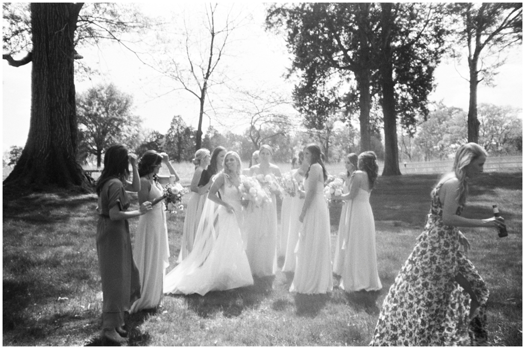 Black and white candid of bride and bridesmaids getting ready